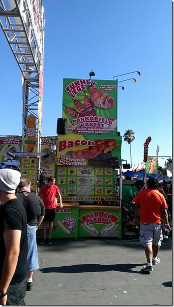 bacon covered turkey leg stand at fair (450x800)