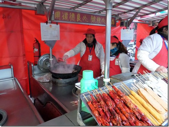 street food vendor frying up buys on a stick for us