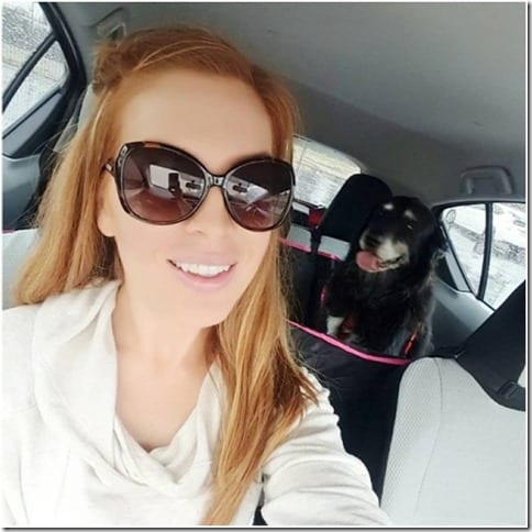 redhead and Roxy dog in car